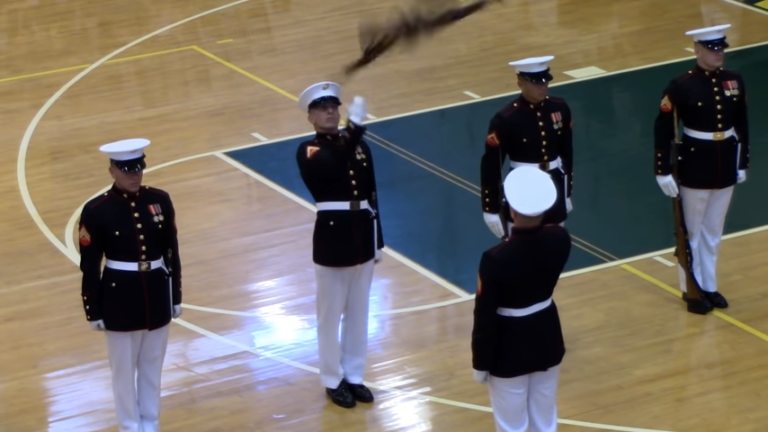 (VIDEO)US Marine stuns crowd when his rifle flies into the air during drill