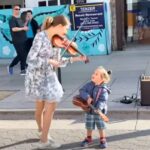 Violin prodigy begins playing Beatles classic but then toddler hops in and steals show