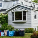 Bags in front of a suburban house ⏐ Source: Shutterstock