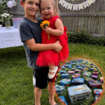 My 8-Year-Old Son Gave Up His Lunch Money to Buy a Little Girl with Down Syndrome a Red Birthday Dress – The Next Morning, Our Lawn Was Covered with Lunchboxes, but What Was Inside the Biggest One Made Him Go Pale